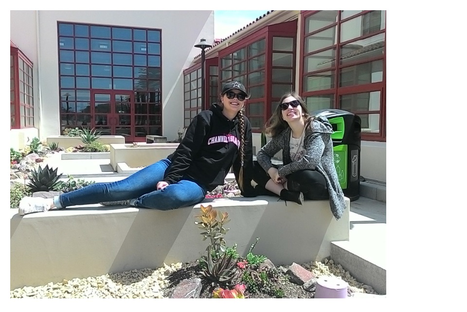 students posing by the garden