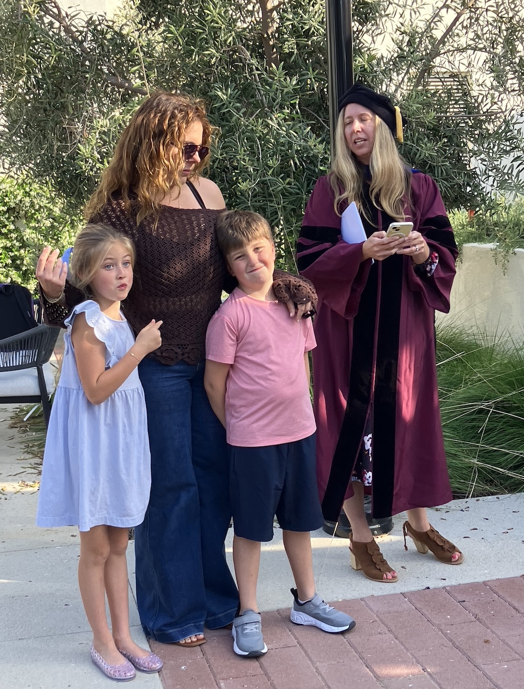 students with her two kids receiving a department awards