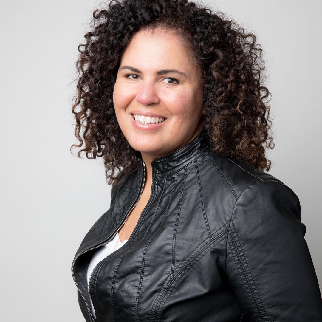 Safiya Noble white background with photo of Safiya Noble in a black jacket