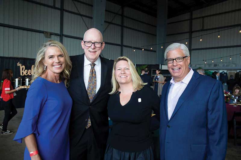 Vanessa and Steve Relyea, President Erika Beck and George Leis
