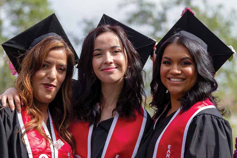 Three graduating students celebrate their new degrees