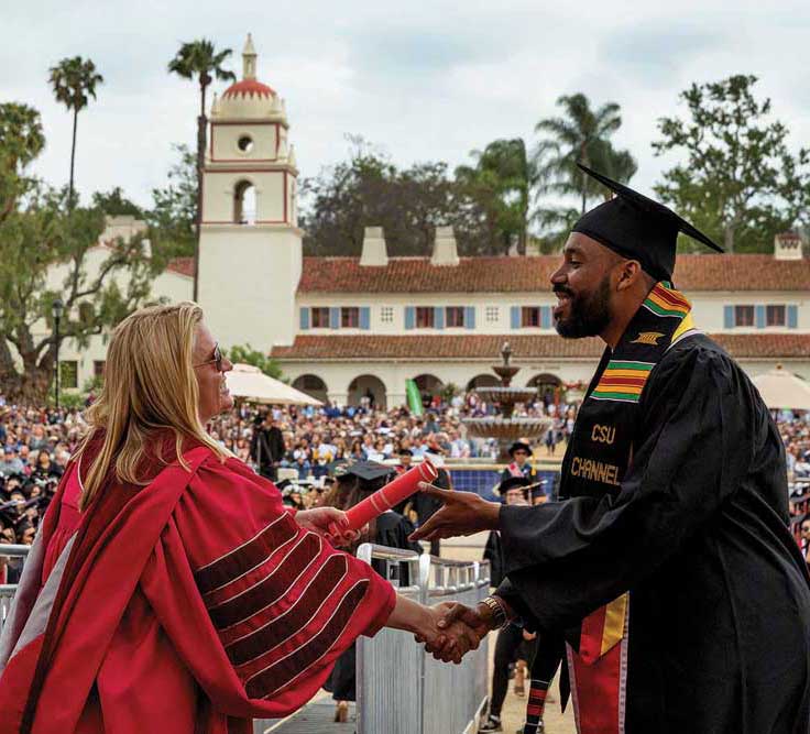 President Erika Beck congratulates a new graduate.