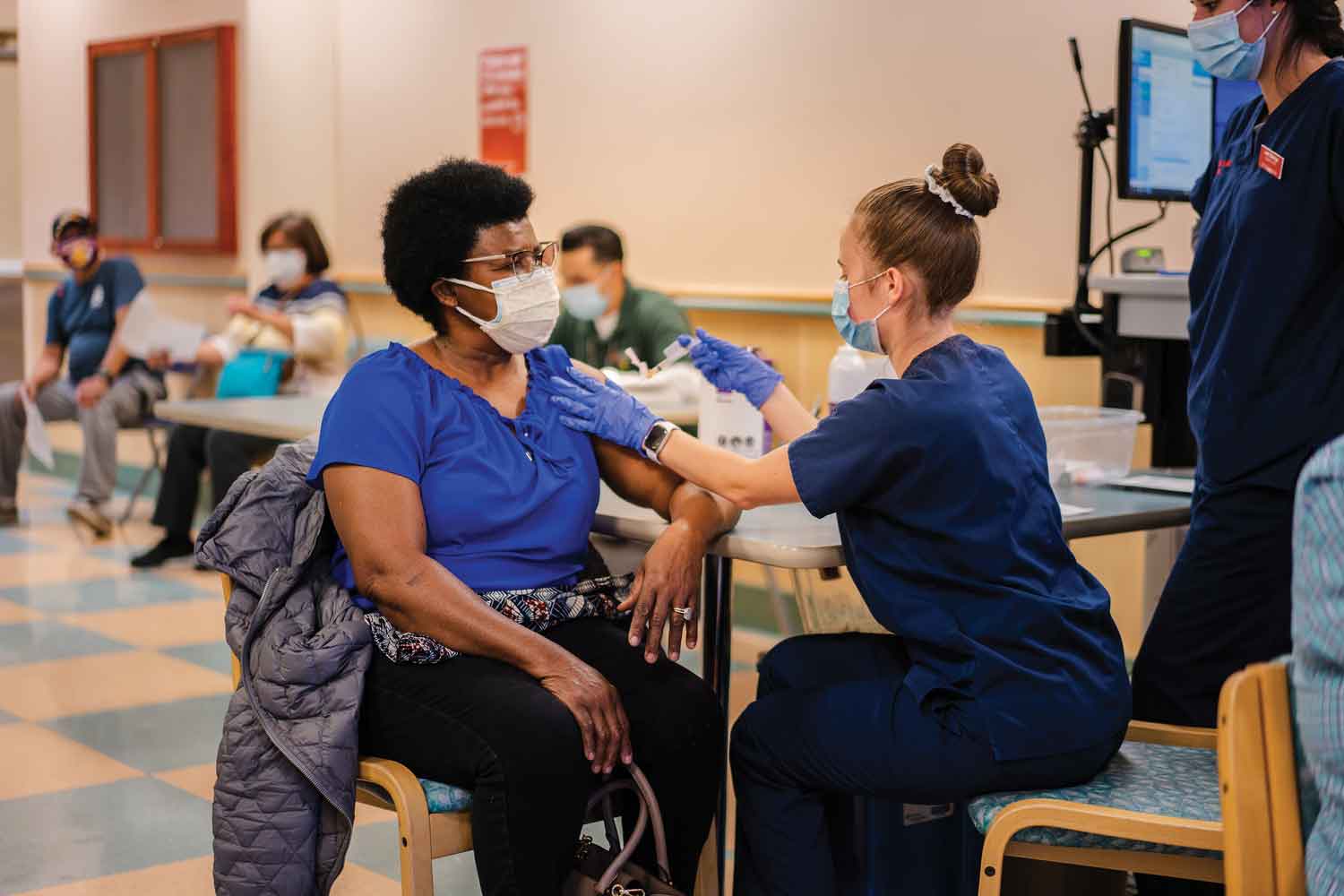 Nursing student Sarah Wilson gives Marie Terzll a vaccine Nursing student Sarah Wilson gives Marie Terzll a vaccine
