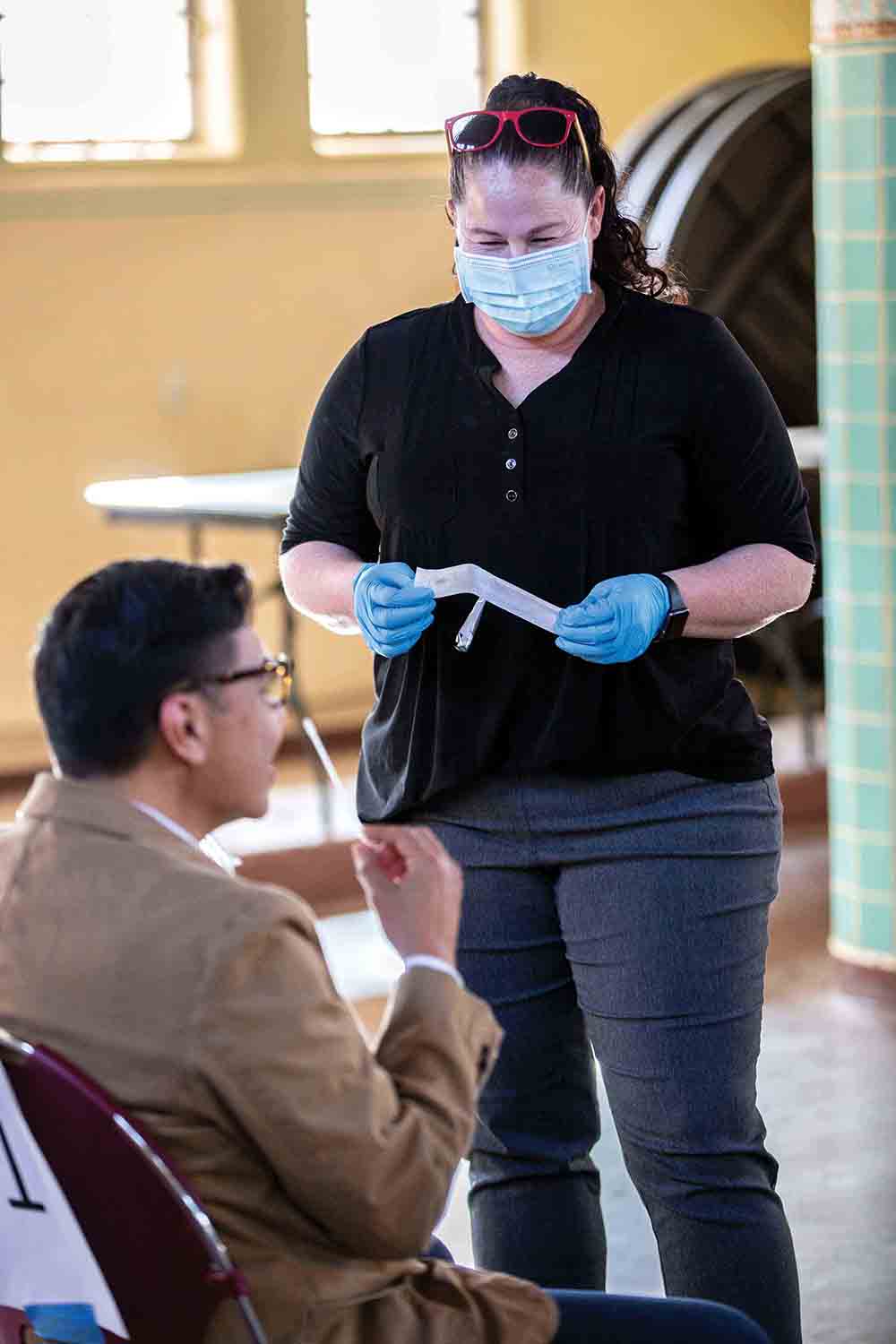 Joyce Spencer conducts a COVID test. Joyce Spencer conducts a COVID test.