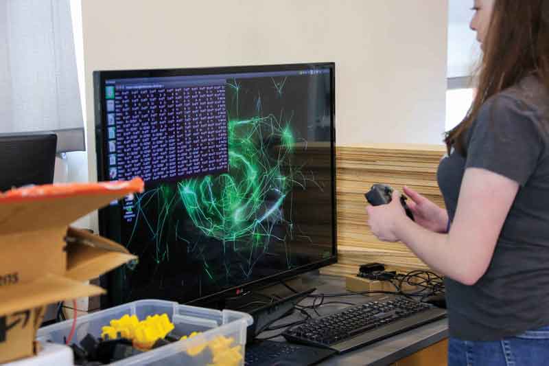 Mechatronics Engineering and Computer Science double major student Kenna Chase, programs aspects of the robot’s operating system code.