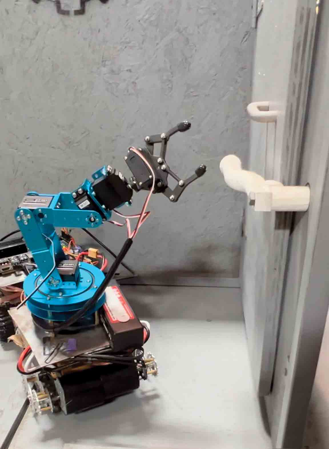 The robot arm in action, moving to grab a pipe. The robot arm in action, moving to grab a pipe.