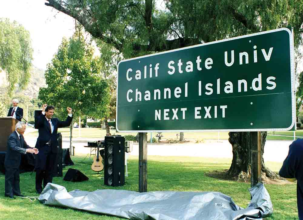 A University highway sign is unveiled in 1999 by then President J. Handel Evans, State Assemblymember Nao Takasugi, and State Senator Jack O’ Connell. A University highway sign is unveiled in 1999 by then President J. Handel Evans, State Assemblymember Nao Takasugi, and State Senator Jack O’ Connell.
