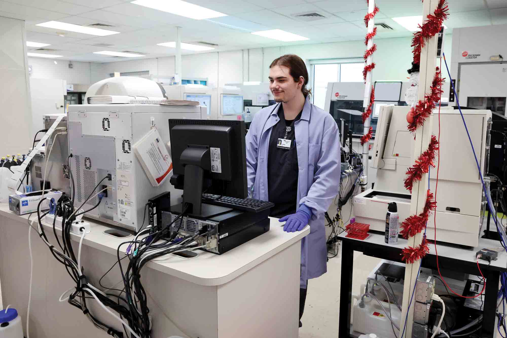 CSUCI ’24 B.S. Biology alum Jason Evans and current CLS student, works in a lab at Community Memorial Hospital.