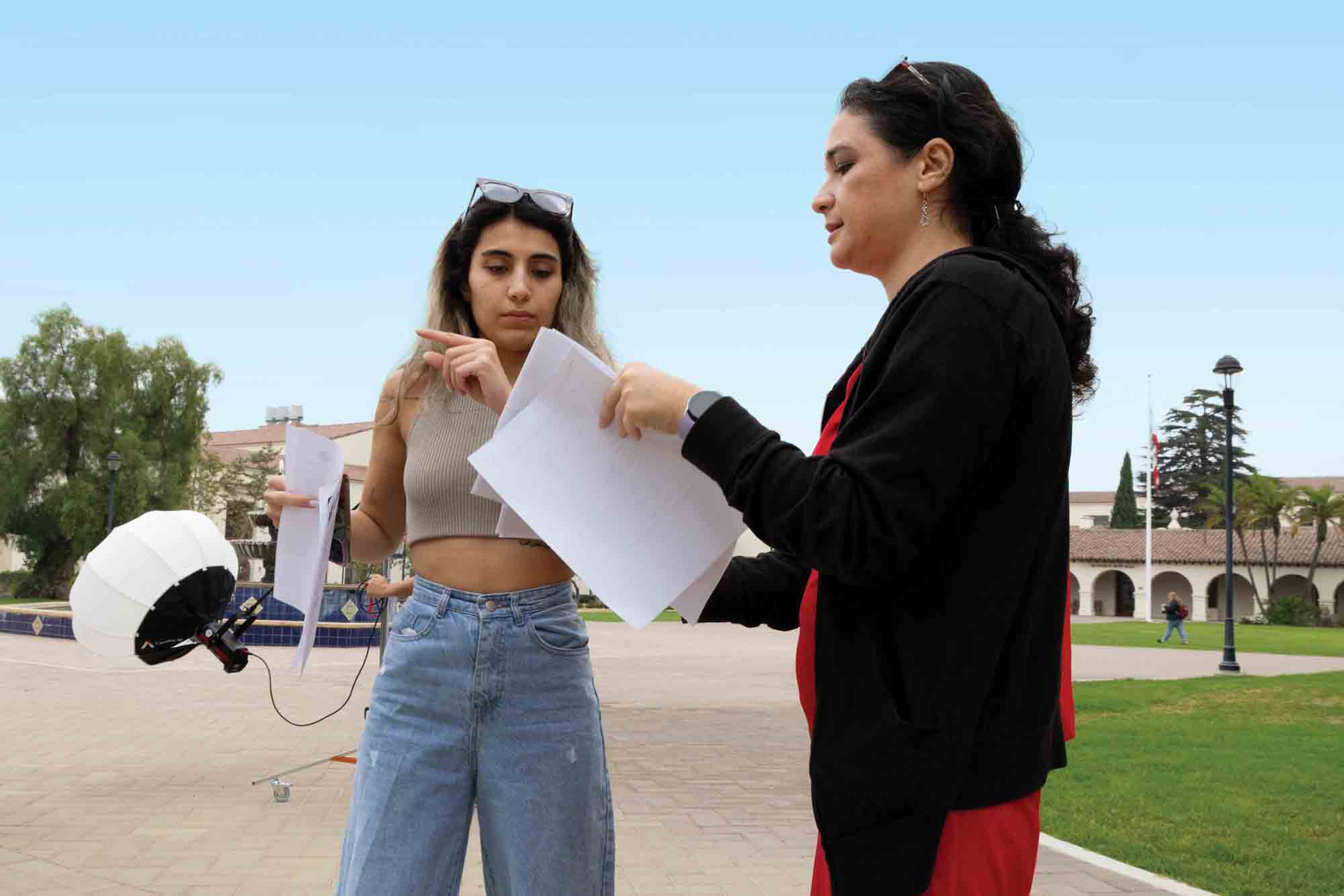 Pehlivan helps a student with a project.