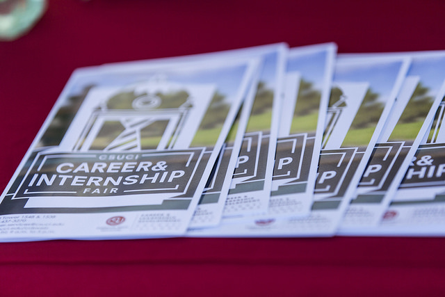 A spread out stack of fliers for the career fair 
