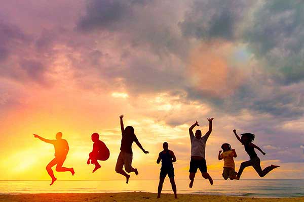 People jumping up in the sunset